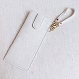 Sleek glass case bag charm with a button-up closure and strap attachment, offering a stylish and convenient way to carry your glasses on the go.