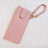 Sleek glass case bag charm with a button-up closure and strap attachment, offering a stylish and convenient way to carry your glasses on the go.