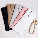 Sleek glass case bag charm with a button-up closure and strap attachment, offering a stylish and convenient way to carry your glasses on the go.