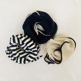 Lightweight knit scarf with a slim, minimalist design, perfect for layering and adding subtle warmth and style to any outfit.