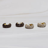 A pair of small gold-tone hoop earrings encrusted with sparkling rhinestones