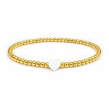 Gold beaded bracelet with a heart-shaped charm on a white background