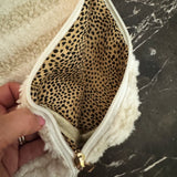 Small quilted white travel pouch with bubble texture, ideal for makeup or toiletries, compact and lightweight