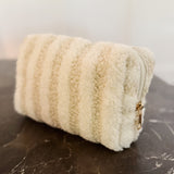 Small quilted white travel pouch with bubble texture, ideal for makeup or toiletries, compact and lightweight