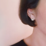 Set of two pearl earrings featuring playful sunny-side-up egg and classic pearl designs, combining whimsy with elegance.