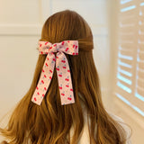 Colorful hair clip featuring a playful fruit print with lemons, strawberries, and cherries—adding a fun, fresh pop to any hairstyle.
