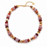 A beaded necklace featuring a mix of polished round beads in dusty pink, terracotta, orange, and deep red, interspersed with smaller striped and textured stone beads, finished with a gold chain clasp and a small branded tag.