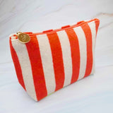 Versatile cosmetic pouch made from soft terry fabric with colorful striped detailing—perfect for storing makeup, toiletries, or everyday essentials on the go.