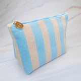 Versatile cosmetic pouch made from soft terry fabric with colorful striped detailing—perfect for storing makeup, toiletries, or everyday essentials on the go.