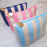 Versatile cosmetic pouch made from soft terry fabric with colorful striped detailing—perfect for storing makeup, toiletries, or everyday essentials on the go.