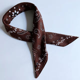 Lightweight textured square scarf with a soft finish, ideal for accessorizing hair, necklines, or handbags with effortless elegance.