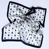 Lightweight textured square scarf with a soft finish, ideal for accessorizing hair, necklines, or handbags with effortless elegance.