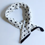 Lightweight textured square scarf with a soft finish, ideal for accessorizing hair, necklines, or handbags with effortless elegance.