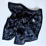 Lightweight textured square scarf with a soft finish, ideal for accessorizing hair, necklines, or handbags with effortless elegance.