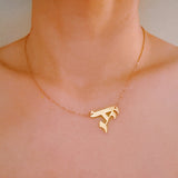 Gold-tone chain necklace featuring a bold Gothic-style initial charm that hangs asymmetrically to the side, adding a vintage-inspired yet edgy detail to your layered look.