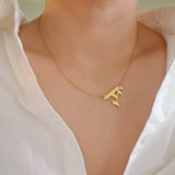 Gold-tone chain necklace featuring a bold Gothic-style initial charm that hangs asymmetrically to the side, adding a vintage-inspired yet edgy detail to your layered look.