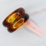 Stylish hair tie featuring a glossy tortoise-shell dome accent—perfect for adding a chic, polished touch to ponytails or buns.