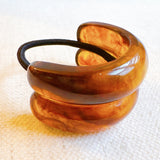 Stylish hair tie featuring a glossy tortoise-shell dome accent—perfect for adding a chic, polished touch to ponytails or buns.