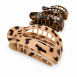 Two leopard print hair clamps on a white background