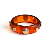 Tortoise bangle with gold accents on a white background