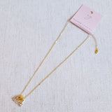 Gold-tone pendant necklace featuring a trio of stacked charms with sparkling crystal accents in a delicate layered design.