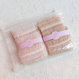 Set of two socks adorned with cascading tulle lace detailing, adding a soft, romantic flair to any look.
