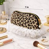Leopard print makeup bag with measurements on a white surface with makeup items.