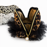 Leopard print headband with black tulle and gold zipper on a white background