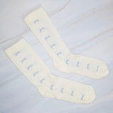 Set of two socks featuring tulle top accents with neatly lined-up bows, offering a delicate and elegant touch to any outfit.