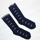 Set of two socks featuring tulle top accents with neatly lined-up bows, offering a delicate and elegant touch to any outfit.