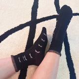 Set of two socks featuring tulle top accents with neatly lined-up bows, offering a delicate and elegant touch to any outfit.