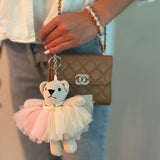 Adorable bag charm featuring a ballerina bear dressed in a tutu with a scrunchie-style attachment—adding a whimsical and playful touch to any bag or backpack.