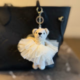 Adorable bag charm featuring a ballerina bear dressed in a tutu with a scrunchie-style attachment—adding a whimsical and playful touch to any bag or backpack.