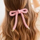 Rope-style hair clip in a sculptural bow shape, featuring a textured twisted design that adds playful elegance and volume to any hairstyle.