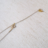 Delicate two-tone necklace featuring a petite heart pendant with a metal finish on a fine chain.