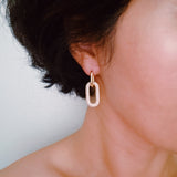 Sleek gold-tone drop earrings featuring modern rectangular chain links with a polished finish, and a sparkling link creating a bold yet refined statement for everyday or evening wear.