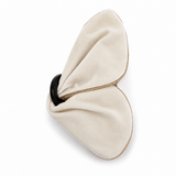 A cream-colored velvet hair claw clip with a black plastic inner band and gold-toned metal edge, shown on a plain white background.