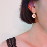 Gold-tone vintage-style drop earrings featuring an oval cameo with delicate pink rose floral design and ornate top stud
