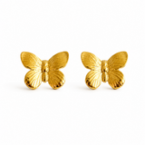 Gold butterfly earrings on a white background