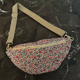 floral sling bag with adjustable strap and front zipper, available in Cherry Meadow, Indigo Bloom, and Midnight Daisy prints