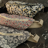 floral sling bag with adjustable strap and front zipper, available in Cherry Meadow, Indigo Bloom, and Midnight Daisy prints