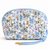 Quilted cosmetic case featuring a vintage-inspired floral print with soft padding and a structured shape, designed for storing makeup and small essentials.