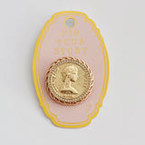 Round vintage-style brooch pin featuring a raised gold-tone medallion design of a classical female profile, bordered with beaded detailing and antique finish for an old-world charm.