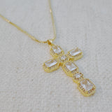 Gold-tone necklace featuring a vintage-inspired cross pendant adorned with sparkling crystals for a timeless and elegant look.