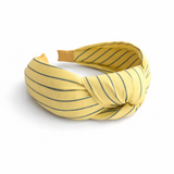 A striped fabric knot headband featuring a soft, twisted design and comfortable fit. This accessory adds a playful yet polished touch to any outfit, perfect for casual or chic looks