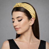 A striped fabric knot headband featuring a soft, twisted design and comfortable fit. This accessory adds a playful yet polished touch to any outfit, perfect for casual or chic looks
