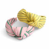 A striped fabric knot headband featuring a soft, twisted design and comfortable fit. This accessory adds a playful yet polished touch to any outfit, perfect for casual or chic looks