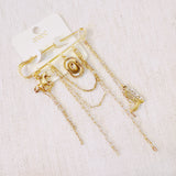 Gold-tone safety pin brooch featuring Western-themed charms including a horse, cowboy hat, boot, and layered chains—perfect for adding rustic flair to any outfit or bag.