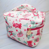Stylish travel cosmetic case featuring a Western-inspired design with whimsical details, sturdy zip closure, and a convenient top handle—perfect for organizing beauty essentials on the go.