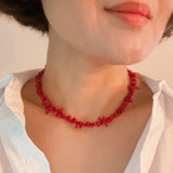 Elegant necklace featuring natural stone beads in coral-inspired shapes, available in two variants—deep red and soft white—each evoking the beauty of coastal reefs with a touch of organic charm.